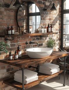 a bathroom with brick walls and a round mirror above the sink, surrounded by white towels