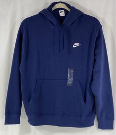 Elevate your athletic wardrobe with this Nike Sportswear Club Fleece Hoodie. The navy blue sweatshirt features a pullover style with a drawstring closure and kangaroo pocket, making it the perfect addition to your fall, winter and spring sports athleisure collection. The Nike logo accents add a touch of style to the hoodie, which is made of 80% cotton and 20% polyester fleece fabric that is both comfortable and machine washable. This hoodie is a regular fit and is available in XL size for men as Navy Blue Sweatshirt, Men's Sportswear, Navy Hoodie, Blue Sweatshirt, Blue Nike, Nike Hoodie, Cute Everyday Outfits, Looks Chic, Midnight Navy