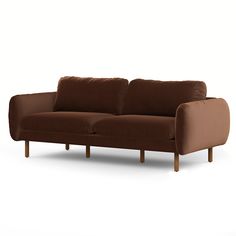 a brown couch sitting on top of a white floor