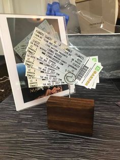 a bunch of tickets sitting on top of a table next to a small wooden box