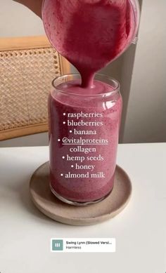 a glass filled with liquid sitting on top of a table