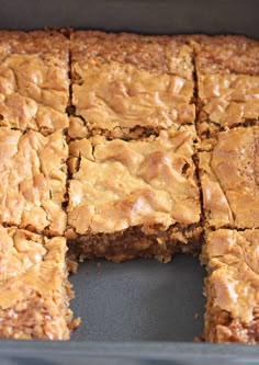 a pan filled with brownies cut into squares and stacked on top of each other