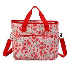 a red and white flowered bag on a white background, with a red strap