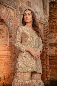 Buy Embellished Pakistani Gharara Dress for Wedding in premium quality organza and tissue emblazoned with shimmering goldwork. Custom Sizes. Fast Shipping. Elegant Jamawar Sharara For Wedding, Jamawar Sharara With Resham Embroidery For Reception, Gold Jamawar Dress With Resham Embroidery, Bollywood Style Jamawar Sharara For Reception, Elegant Jamawar Sharara With Dabka Work, Elegant Sharara With Dabka Work In Jamawar, Party Sharara With Resham Embroidery In Jamawar, Designer Brocade Gold Dresses, Gold Brocade Designer Dresses