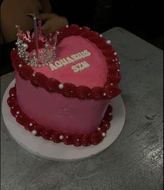 a heart shaped cake with a tiara on top that says aquarius sta