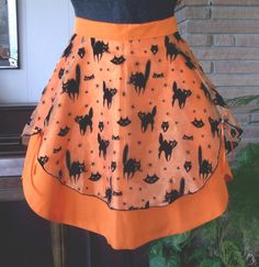 an orange skirt with black cats on it