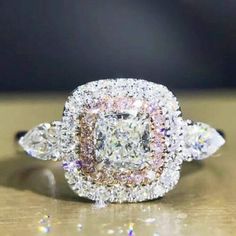 a diamond ring with two rows of diamonds around it on top of a wooden table