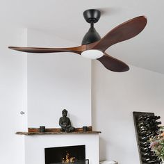 a living room with a fire place and a ceiling fan that is mounted on the wall