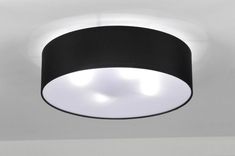 a black and white light hanging from the ceiling