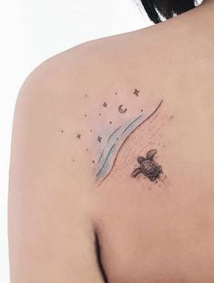 a woman's shoulder with a turtle and moon tattoo on her left side ribcage