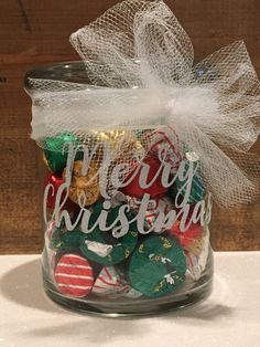 a glass jar filled with assorted christmas candies