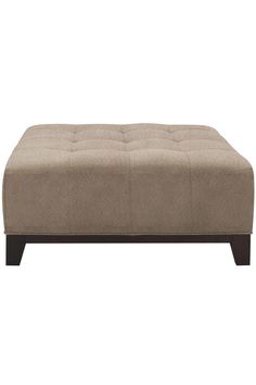 a beige ottoman that is sitting on top of a table