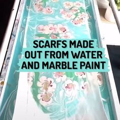 a water slide with flowers on it and the words scarfs made out from water and marble paint