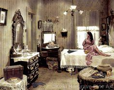 a woman sitting on top of a bed in a bedroom next to a dresser and mirror