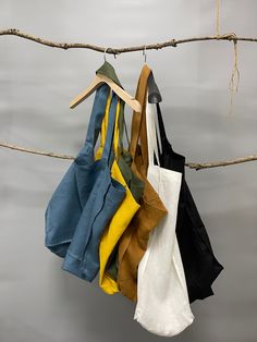 several different colored shirts hanging on a clothes line