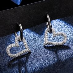 Cubic Zirconia Open Heart EarringsDetails for Earrings: Can be worn everyday or for a night out.Cubic Zirconia Hoop Size - approx. 15mmHeart Size - 19mmHoop + Heart Long measures 30mm in heightThe Heart can be removed and allows you to wear the Rectangle Hoop for a different Style. Each set of Earrings is nicely wrapped in an organza bag. Unless you prefer to select our Gift Package Option During Checkout Everyday Open Heart Earrings, Cubic Zirconia Open Heart Earrings, Silver Open Heart Cubic Zirconia Earrings, Gold Open Heart Hoop Earrings, Nickel-free Open Heart Hoop Earrings, Open Heart, Huggie Hoop Earrings, Stainless Steel Earrings, Crystal Heart