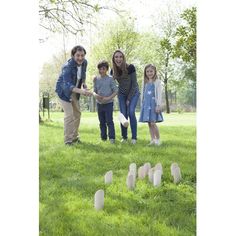 a group of people standing in the grass near tombstones