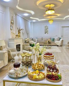 a living room filled with furniture and lots of food on top of a white table