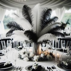 the centerpieces are decorated with feathers and flowers