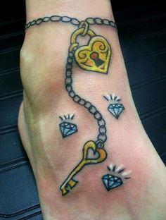 a person with a tattoo on their foot that has a key and chain attached to it