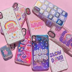 several cases with different designs on them sitting next to each other in front of a pink background