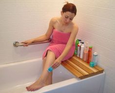 a woman sitting in a bathtub with her foot on the edge