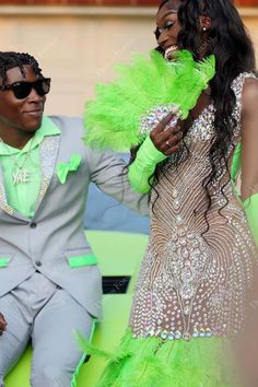 Shiny crystals decorated on the V-neck bodice of designer trumpet prom dress with sweep train. The lime green Ostrich feathered bottom brings gorgeous flair. shown color lime green bra support removable cups boning no closure back zipper lining partially lined * This item does not include gloves. Lime Green Prom Dress Couple, Green And White Prom Dress, Lime Green Prom Couple, Prom Color Ideas For Couples, Green Prom Couple, Prom Color Ideas, Prom Dress With Gloves, Lime Green Prom Dresses, Prom Fits