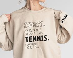 Customize this tennis mom shirt to meet your needs! Choose from short sleeve, long sleeve, hoodies, and crewneck sweatshirts and add your favorite players name! Other color options and styles are available. If you don't see what you're looking for send us a message! The shirts are a UNISEX retail fit - they are more of a relaxed fit and may run a little large on women and those with a smaller frame . Make sure to see the size charts (last images) to confirm the best fit for you. We recommend mea Tennis Spirit Wear, Cotton Tennis Sweatshirt With Relaxed Fit, Cotton Tennis Sweatshirt In Relaxed Fit, Tennis Graphic Print Sweatshirt For Sports Season, Relaxed Fit Screen Print Sweatshirt For Sports Season, Relaxed Fit Sweatshirt With Screen Print For Sports Season, Tennis Graphic Print Sweatshirt, Relaxed Fit Sports Season Sweatshirt With Screen Print, Long Sleeve Graphic Sweatshirt For Tennis