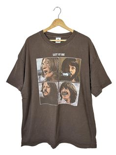 a brown t - shirt with the words let it be on it, and three pictures of