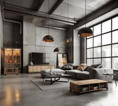 an industrial living room with large windows and gray furniture