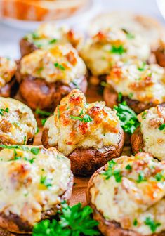 closeup of baked potatoes with cheese and parsley on the top, ready to be eaten