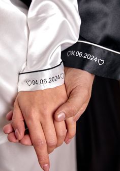 two people holding hands with their names on them