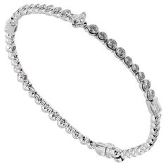 An incredible tennis bracelet by Louis Vuitton showcasing alternating sized round brilliant cut diamonds, iconic Les Ardentes shaped central diamond and baguette diamonds in shimmering 18k white gold. 5ct Appx Diamond Weight Louis Vuitton High Jewelry, Bracelets Tennis, White Gold Diamond Bracelet, Gold Tennis Bracelet, Bracelet Tennis, Vintage Tennis, Modern Bracelets, Gold Chanel, Louis Vuitton Jewelry