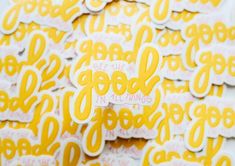 yellow and white stickers with the words good in all things written on them are shown