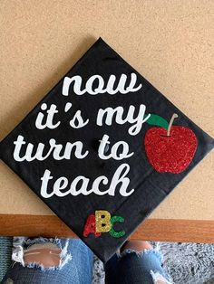 a black graduation cap that says now it's my turn to teach