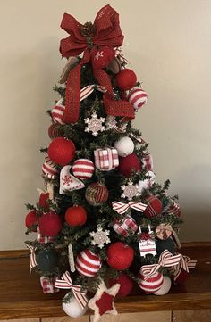 a decorated christmas tree with red and white ornaments