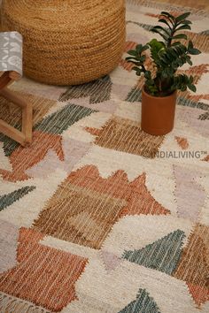 a potted plant sitting on top of a rug next to a wooden chair and ottoman