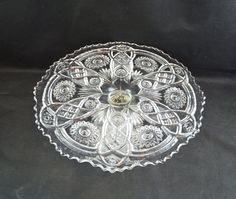 an ornate glass dish on a black background