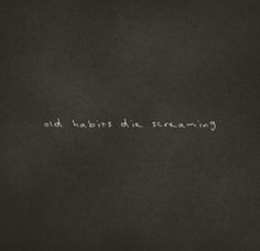 the words old habitts die screaming are written in white chalk on a black background