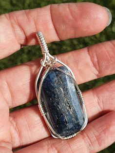 Blue Kyanite pendant wrapped in sterling silver. Unique stone with veins of sparkly mica.  Kyanite grounds spiritual energy and aligns the chakras. Helpful to connect with guides during mediation.  Linked to the throat chakra helps to speak through truth. As Kyanite doesn't hold negative energies does  it need to be cleansed. 50cm silver filled chain included. If would prefer 45cm leather necklace, advise in message during purchase. Kyanite Necklace Handmade, Sapphire Kyanite Necklace For Gifts, Silver Kyanite Jewelry For Gift, Blue Kyanite Necklace For Gift, Blue Kyanite Crystal, Spiritual Energy, Blue Kyanite, Les Chakras, Throat Chakra