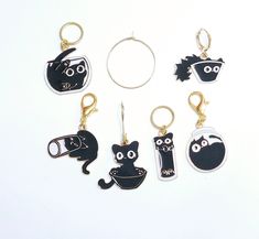 six keychains with different designs on them sitting next to each other in front of a white background