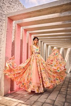 With the Printed Chic Gown, no detail is too small. This exquisite creation showcases expert tailoring, delicate embellishments, and luxurious fabrics, resulting in a piece that exudes refinement and luxury. The voluminous gown billows gracefully with every step, whilst the Heavy Belt accentuates the natural curves of the figure. The Dupatta adds an air of sophistication, flitting delicately with every movement. With its intricate print, this gown is the epitome of sophistication and charm. Off Shoulder Lehenga, Ruffle Lehenga, Raw Silk Lehenga, Gown With Dupatta, Mirror Work Blouse, Yellow Lehenga, Designer Lehengas, Green Lehenga, Ivory Blouse