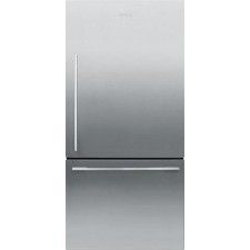 a silver refrigerator freezer sitting on top of a white wall