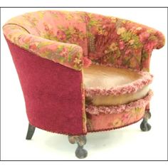 a chair that is sitting on wheels with a flowered upholstered back and seat