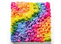 a multicolored piece of art that looks like it has been made out of yarn