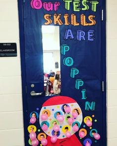 a door decorated with balloons and writing that says our test skills are poppin '