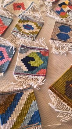 colorful rugs are laid out on the floor with tassels hanging from them