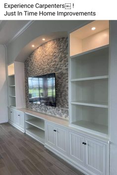 an entertainment center with built in shelves and a flat screen tv mounted on the wall