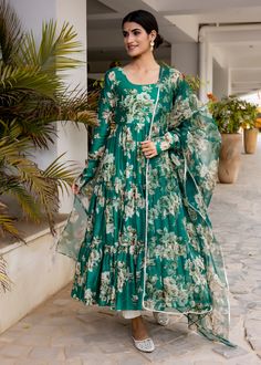 PRODUCT DESCRIPTION :-Flaunt the traditional Aesthetics with this beautiful bottle green floral printed tier pattern Anarkali . It is all set to steal the hearts with it`s pretty print and details.Anarkali :- chanderi cottonPant :- CottonDupatta :- Organza silkClosure Used:- Side zipColor:-Anarkali and dupatta - bottle green Pant - off whiteCare Instructions :- Dry clean onlyModel Size :- Model is wearing XS sizeModel Height :- 5.6''DISCLAIMER :- Slight color variations may occur due to differen Bollywood Style Green Floral Sharara, Green Bollywood Style Sharara With Floral Print, Transitional Green Anarkali Set With Dabka, Green Sharara With Floral Print And Straight Kurta, Green Floral Print Sharara With Straight Kurta, Green Printed Sharara For Wedding, Green Sharara With Printed Motifs For Wedding, Bollywood Style Green Kurta With Floral Print, Bollywood Green Floral Print Kurta