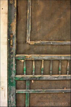 an old wooden door with peeling paint on it